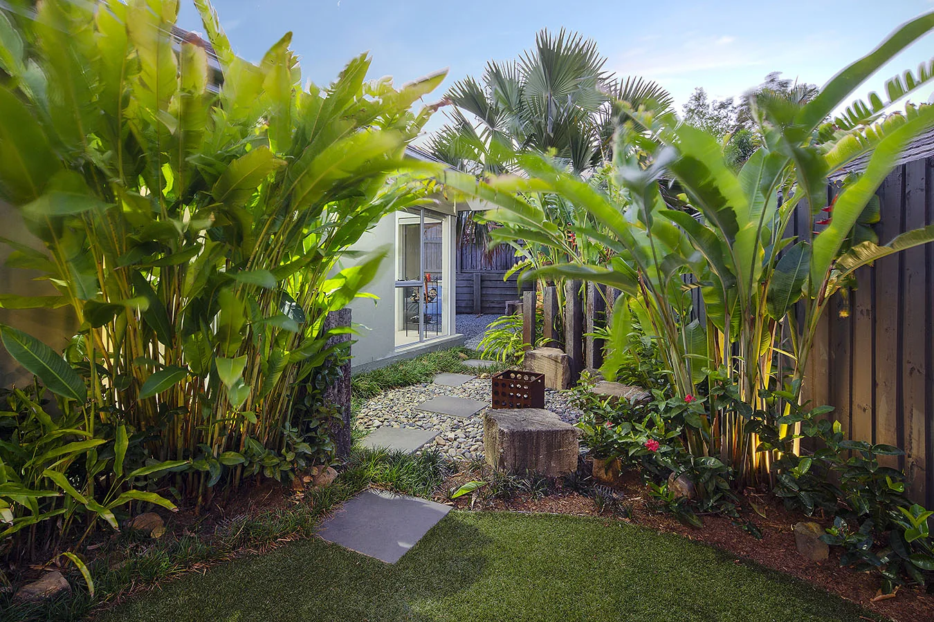 Dense wall of golden cane palms with a glimpse of a doorway beyond